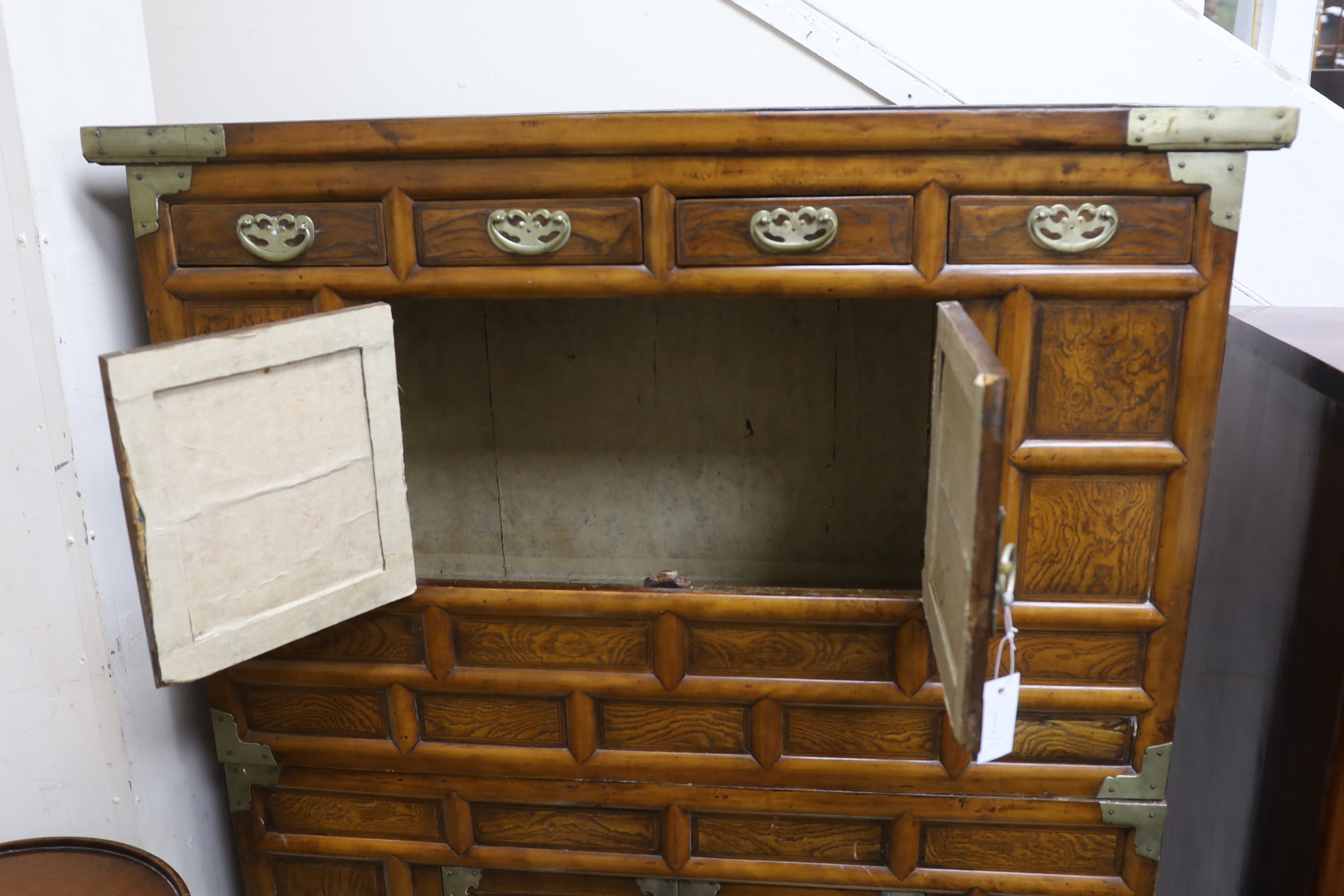 A Korean gilt metal mounted elm two part side cabinet, width 108cm, depth 46cm, height 149cm